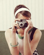 Foto: Retro woman with old-fashioned camera Retro woman with old-fashioned camera
