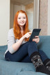  girl with e-book on sofa