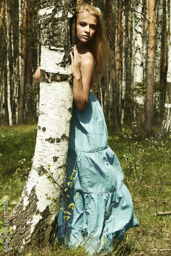 Photo: Beautiful blond woman in summer forest Beautiful blond woman in summer forest