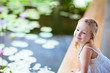 Photo: Little girl near lily pond Little girl near lily pond