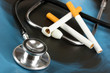 Medical stethoscope on x-ray picture with cigarettes close up