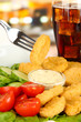 Photo: Fried chicken nuggets with vegetables,cola and sauce isolated Fried chicken nuggets with vegetables,cola and sauce isolated