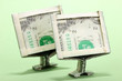 Dollars folded into computer monitors on green background