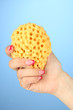 Foto: Female hand with wisp, on color background Female hand with wisp, on color background