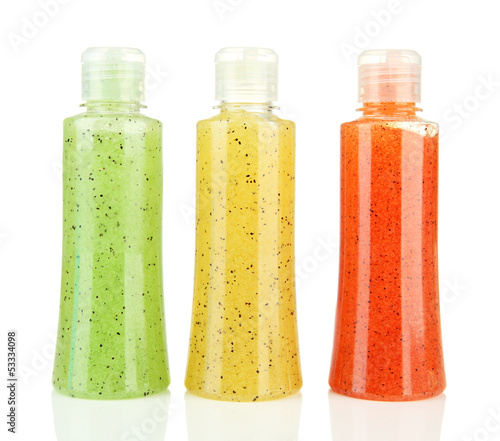 Photo: Bottles with scrub isolated on white Bottles with scrub isolated on white