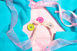 Three buttons on light pink and blue cloth
