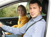 Photo: Portrait of young beautiful couple sitting in the car Portrait of young beautiful couple sitting in the car