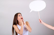 Photo: Young pretty woman with empty think bubble on grey background Young pretty woman with empty think bubble on grey background
