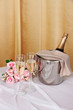 Champagne and glasses on round table on cloth background