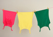 Laundry line with clothes on wall background
