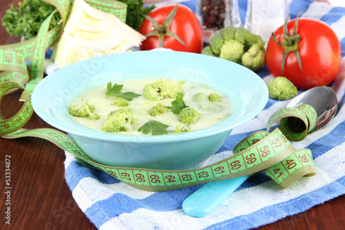 Photo: Cabbage soup in plates on napkin on wooden table Cabbage soup in plates on napkin on wooden table