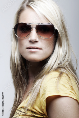 Photo: Gorgeous female model posing in sunglasses Gorgeous female model posing in sunglasses