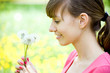 Photo: Happy girl admiring dandelions Happy girl admiring dandelions