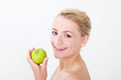 blonde model holding green apple