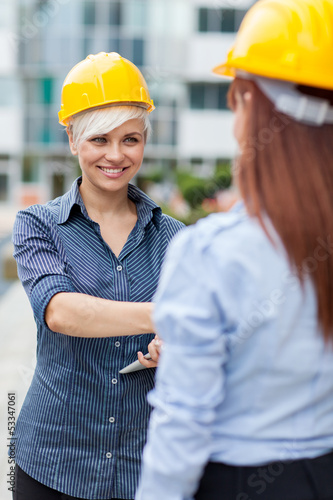 Photo: Two Constructors meet and shaking hands Two Constructors meet and shaking hands