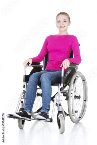Photo: Attractive smiling disabled woman sitting in a wheel chair Attractive smiling disabled woman sitting in a wheel chair