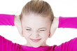 Closeup of frustrated young woman holding her ears.
