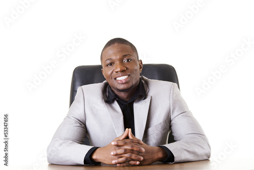 Photo: Happy successful businesman at the desk. Happy successful businesman at the desk.