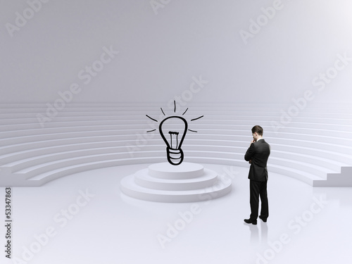 Photo: businessman looking on lamp businessman looking on lamp
