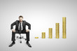Photo: businessman sitting on chair and coins businessman sitting on chair and coins