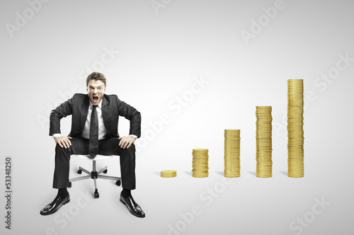 Photo: businessman sitting on chair and coins businessman sitting on chair and coins