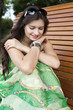 Brunette sitting on a bench in a summer park