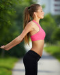 Pregnant woman does sports exercises outdoor