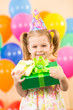 Photo: smiling child girl with gidts on birthday party smiling child girl with gidts on birthday party