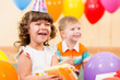 Photo: happy child girl with colorful balloons and gift happy child girl with colorful balloons and gift