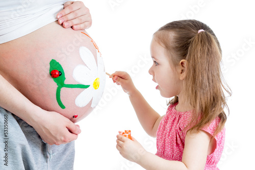 Photo: cute kid girl painting mother's belly cute kid girl painting mother's belly