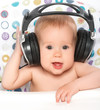 Photo: happy baby with headphones listening to music happy baby with headphones listening to music