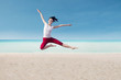 Attractive dancer jumping on beach