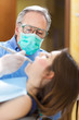 Dentist curing a female patient