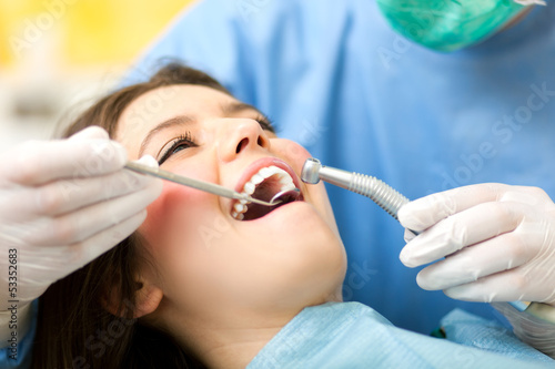 Photo: Dentist curing a female patient Dentist curing a female patient