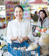 mature woman buys garlic for planting