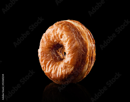 Photo: Croissant and doughnut mixture isolated on black Croissant and doughnut mixture isolated on black
