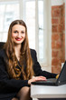 woman in office sitting on the computer