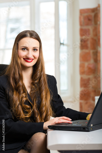 Photo: woman in office sitting on the computer woman in office sitting on the computer