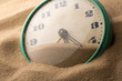 Alarm clock in sand
