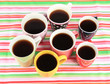 Many cups of coffee on striped napkin