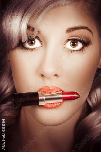 Photo: Surprised pinup girl with lipstick makeup in mouth Surprised pinup girl with lipstick makeup in mouth