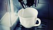 coffee machine pouring cappuccino in cup