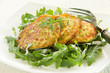 Zucchini fritters with arugula.
