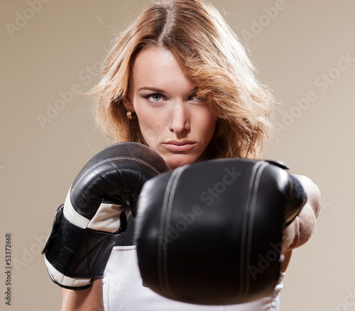 Photo: Portrait of blonde sportish woman in boxing gloves Portrait of blonde sportish woman in boxing gloves