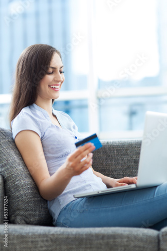 Photo: Woman with laptop and credit card Woman with laptop and credit card