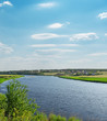 Foto: river with green riverside and light cloudy sky river with green riverside and light cloudy sky