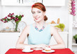 Photo: Beautiful smiling woman on the kitchen Beautiful smiling woman on the kitchen
