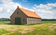 Photo: Old Dutch barn of brick masonry with an orange tile roof Old Dutch barn of brick masonry with an orange tile roof