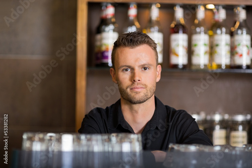 Photo: Confident Male Bartender At Cafe Confident Male Bartender At Cafe