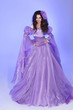 Beautiful woman model posing in Long Chiffon dress over purple i